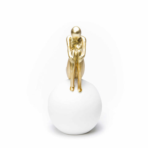 Figure Sitting on White Ball