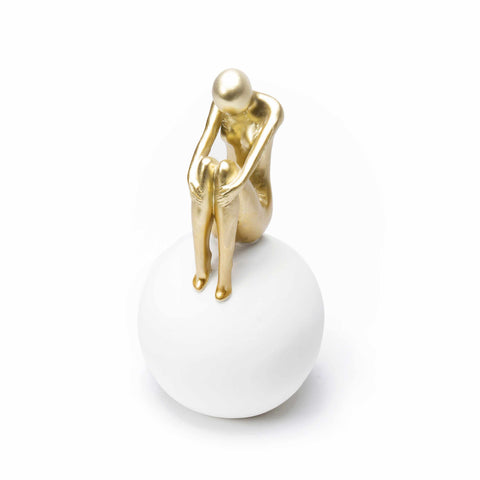 Figure Sitting on White Ball